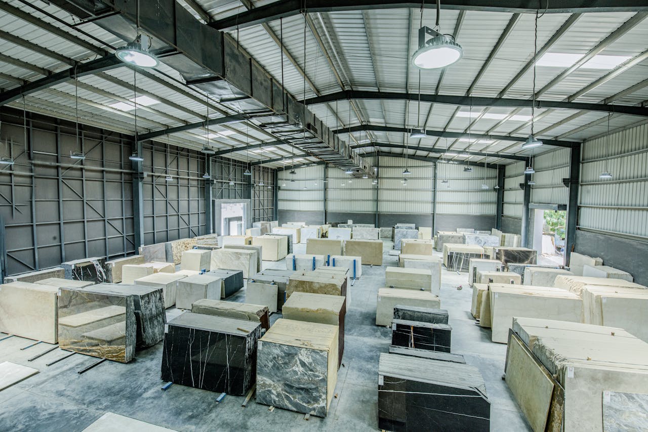 Expansive warehouse filled with large stone slabs for industrial use.